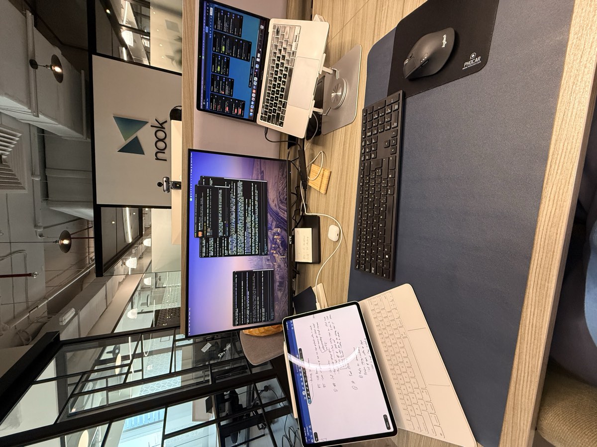 Desk setup at Nook coworking space in Dubai with a monitor, laptop, and iPad
